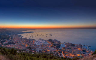 City lit night ocean mountains - bernard meninsky free wallpaper