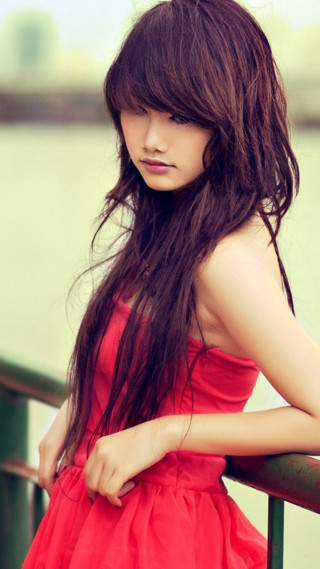 Woman red dress leaning rail - near free wallpaper