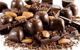 Chocolates nuts white surface background - decadent free wallpaper