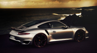 Silver sports car ocean dark - a dark sky in the background free wallpaper