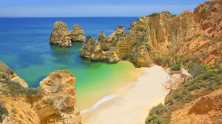 Beach rock formation blue water - a blue body of water free wallpaper