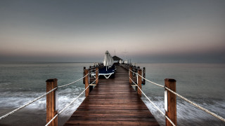 Pier boat tied water dusk - a boat in the distance free wallpaper