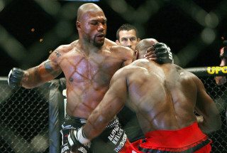 Man standing caged area punching - glove free wallpaper