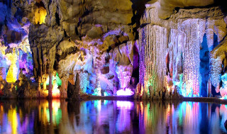 Cave waterfall group people colorful - a cave free wallpaper