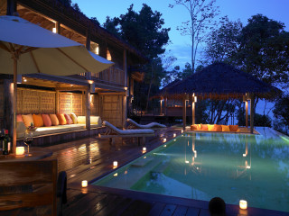 Pool lounge candles nighttime lit - luxury free wallpaper
