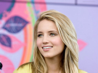 Blonde woman yellow shirt smiling - a colorful wall free wallpaper