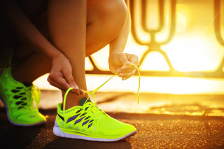 Woman tying shoelaces tennis shoe - a sidewalk free wallpaper