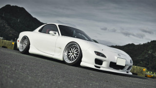 White sports car mountain range - the side of a road near a mountain range free wallpaper