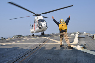 Man yellow jacket ship helicopter - action scene free wallpaper