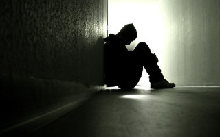 Person sitting dark room feet 2 - somber free wallpaper