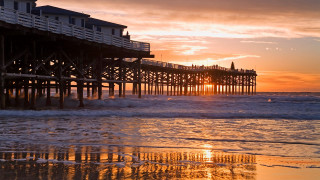 Pier sunset waves crashing person - a pier free wallpaper