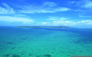 Water island blue sky clouds - a small island in the distance free wallpaper