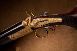 Gun closeup brown background black - a close up of a gun free wallpaper