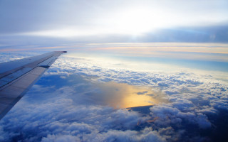 Airplane wing clouds water sun - above the cloud free wallpaper