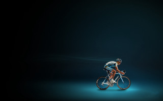 Man riding bike dark background - a bike free wallpaper for desktop