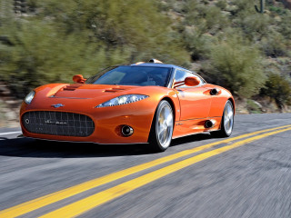 Orange sports car driving road - a forest of trees and bushes free wallpaper