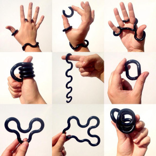 Hands holding black object spiral - kinetic art free wallpaper