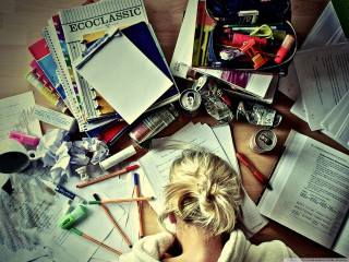 Woman sitting table papers pens - hard focus free wallpaper