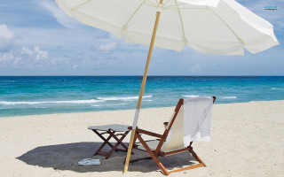 Beach chair umbrella ocean blue - the ocean in the background free wallpaper