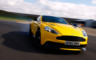 Yellow car driving road grass - a road next free wallpaper