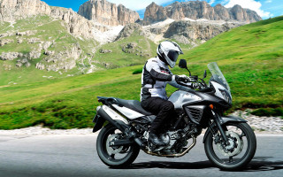 Man motorcycle road green hillside - hill free wallpaper