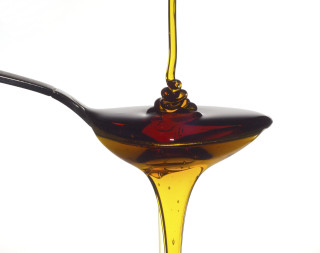 Spoon oil liquid pouring out - a liquid free wallpaper