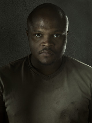 Man brown shirt serious look - derold page free wallpaper