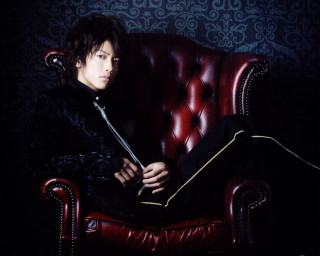 Man sitting red chair sword - magazine free wallpaper