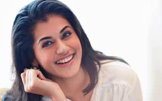 Woman smiling holding ring camera - her finger free wallpaper