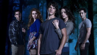 Group people forest trees background - a blue light behind them free wallpaper