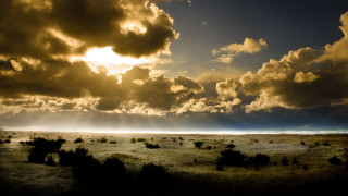 Grass field clouds sky sunbeam - a sunbeam in the distance free wallpaper