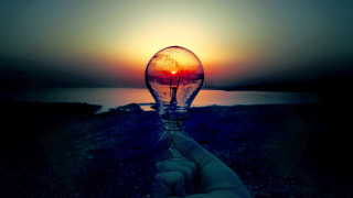 Hand lightbulb sunset water background 2 - a surrealist painting free wallpaper