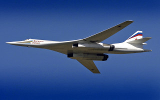 Large jetliner flying blue sky 5 - the side of the plane free wallpaper