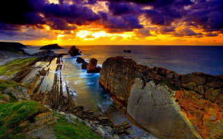 Sunset rocky beach water rock - a sunset over a rocky beach free wallpaper