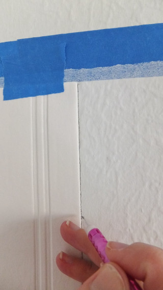 Person holding blue tape wall - hard edge free wallpaper