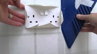 Person holding paper house device - a roof free wallpaper
