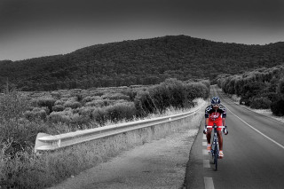 Man riding bike road green - great composition free wallpaper