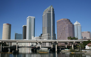 Bridge river boat city tall - the water and a city in the background free wallpaper