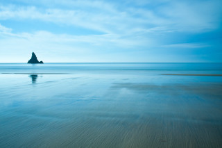 Beach rock distance water blue - tranquil free wallpaper