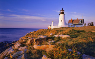 Lighthouse rocky cliff ocean sunset - a lighthouse free wallpaper
