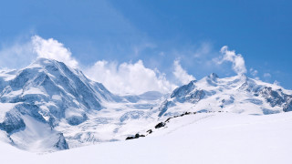 Skiing mountain snowy view person - a snowy mountain top free wallpaper