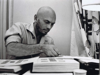 Man sitting table stack books - criterion collection free wallpaper