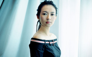 Woman braids curtain eyes closed - a curtain free wallpaper