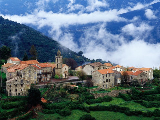Village surrounded by mountains and 2 - a few building free wallpaper