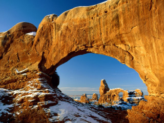 Rock arch snow sky mountain - a large rock formation free wallpaper