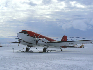 Small airplane snow covered field - top of a snow free wallpaper