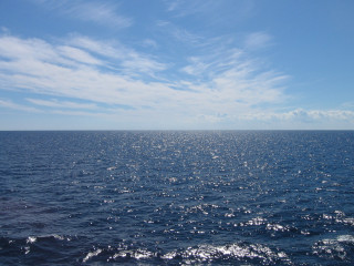 Water sky clouds boat reflection - ocean free wallpaper