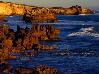 Rocky shore waves lighthouse autumn - wave free wallpaper