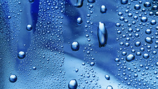 Water droplets blue surface background - a close up of water droplets free wallpaper