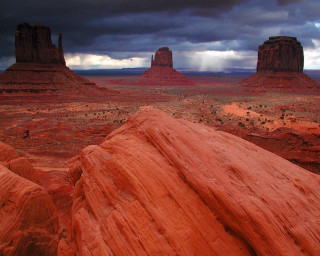 Large rock formation desert cloudy 4 - a large rock formation in the middle of a desert area free wallpaper